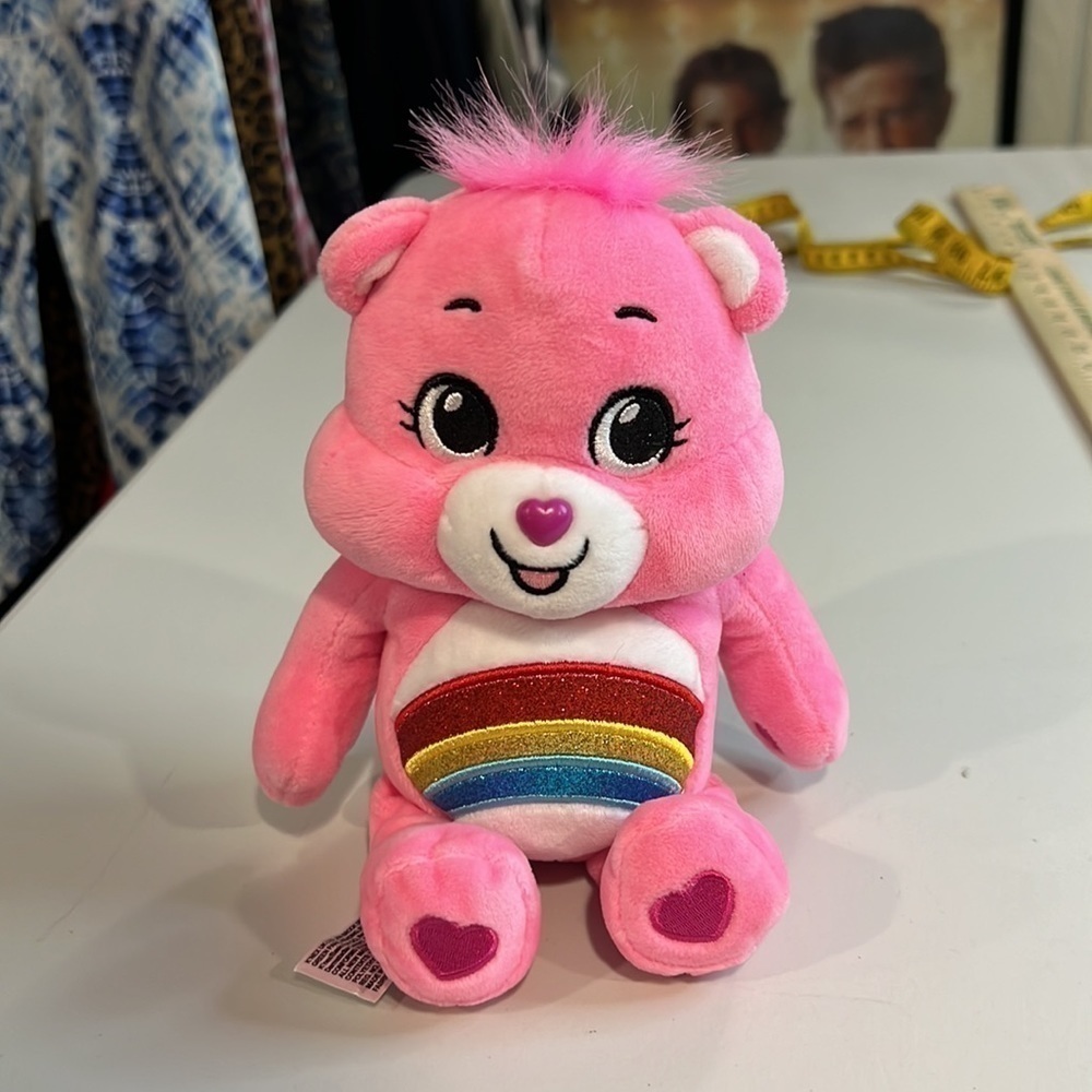 Care Bear Cheer Bear Plush with sparkles on rainbow